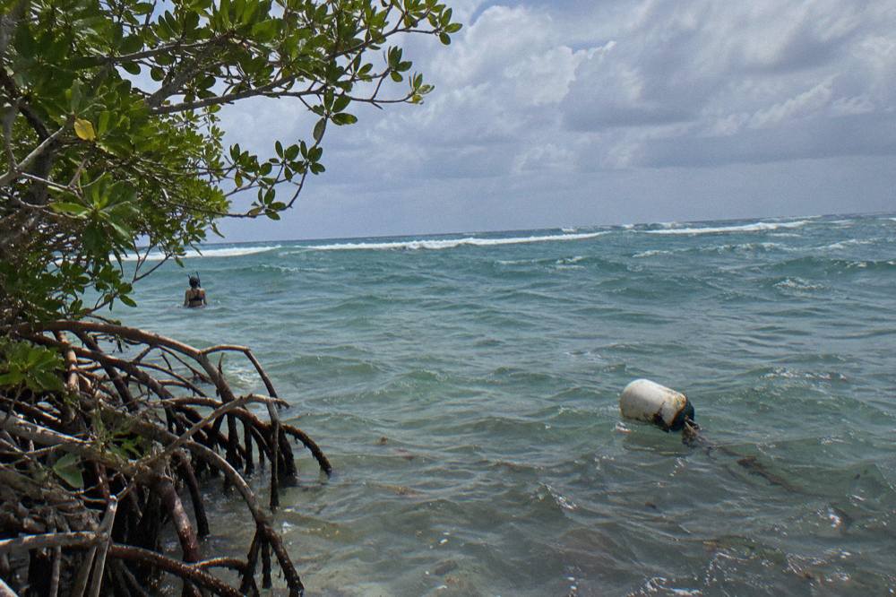 Open blue sea with whitecaps and no land in sight under scattered clouds