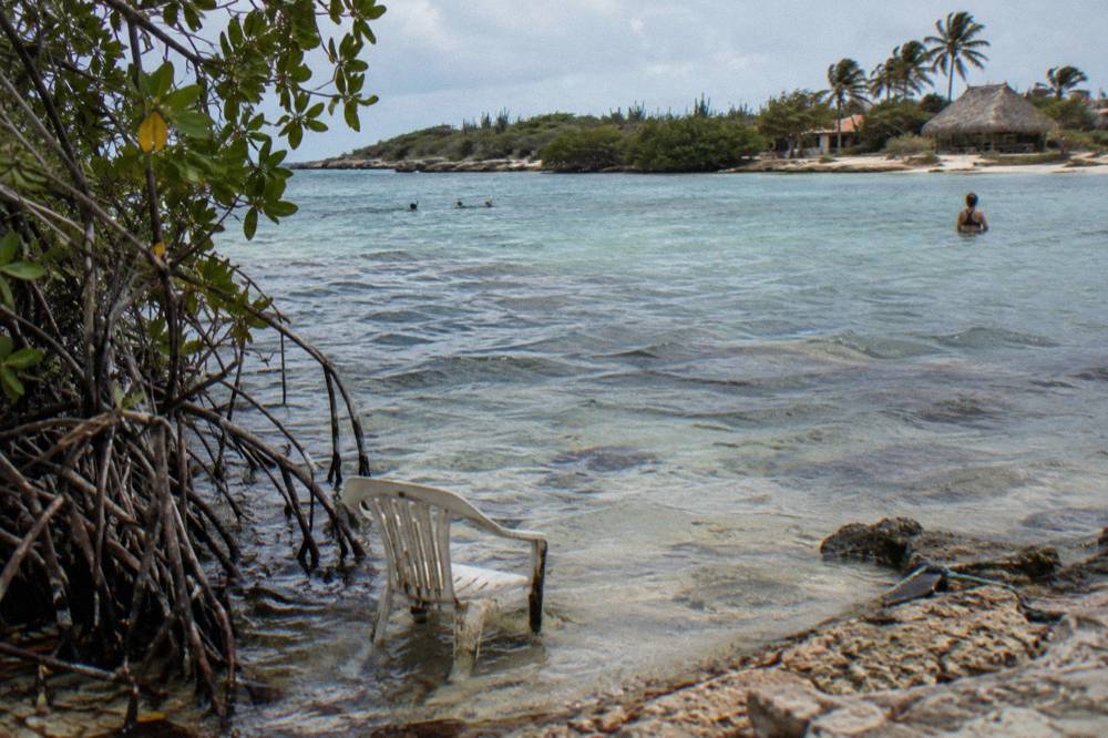A calm sheltered bay with clear shallow water over a nearshore reef