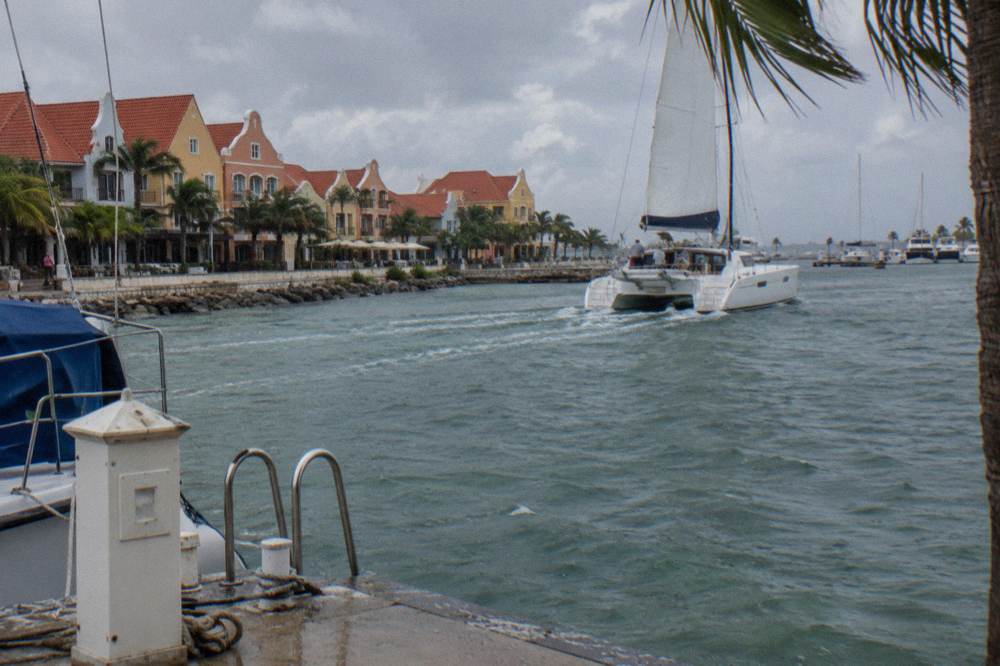 Catamaran under sail on calm blue water near the Aruba coast