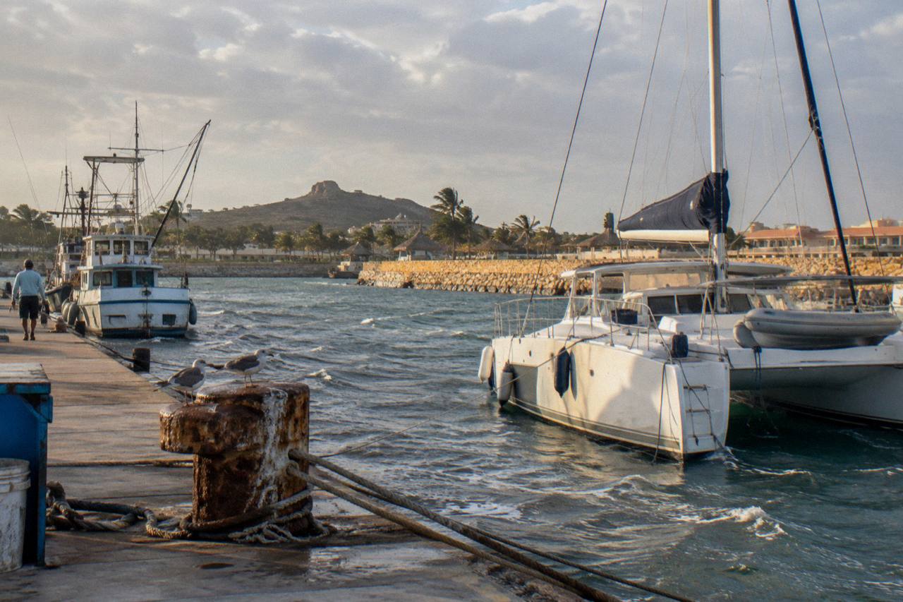 Private charter catamaran waiting at the quay of Varadero Marina, Aruba, late afternoon